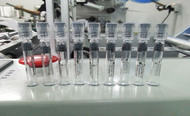 labelled transparent label syringes by the bench top Syringe
