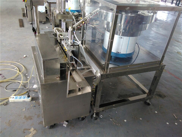 side view of  cap wadding lining machine induction sealing w